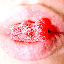 Vivid Red Gummy Candy in a Woman's Mouth