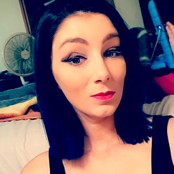 Amanda, an Onlyfans Model with Short Hair and Red Lipstick in a Room