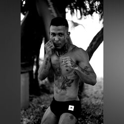 Fashion-forward camel pose, strong jawline and tattoos