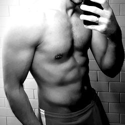 Fitness Model's Shirtless Body in Bathroom Mirror