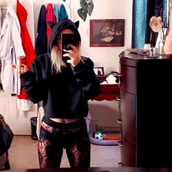 Aizle on Onlyfans, Showing Off Her Tattoos and Black Shirt