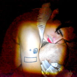 Nude, Busty Model in Casual Pose with Tattoos