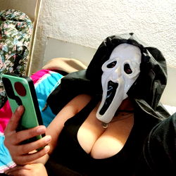 Female Fan Posing with Scream Mask