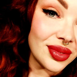 Red-Haired Female with Dark Eye Shadow