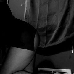 Gorgeous OnlyFans Model Babygirl C in a Sexy Black Outfit, Showcasing Her Curves and Smiling at the Camera