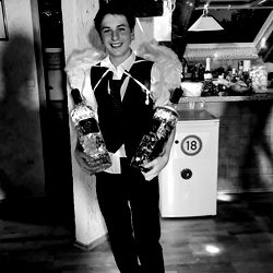 Pasi, a model in Munich Germany, stands confidently holding two bottles of vodka