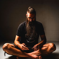 Bearded Man in Squat Pose