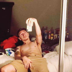 Austin Crane in a Shirtless, Casual Pose, Taking a Selfie
