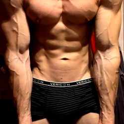 Shirtless Model Posing in Front of Mirror