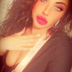 Glamorous OnlyFans Model Poses in Front of Wallpaper