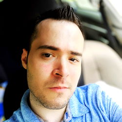 Male Photographer Smiling at Camera