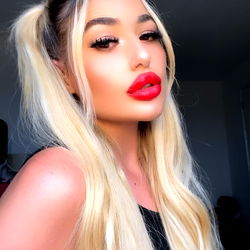 Sophie, the stunning OnlyFans model with vibrant hair and a striking red lip.