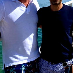 Two Men at a Pier with Clear Blue Water