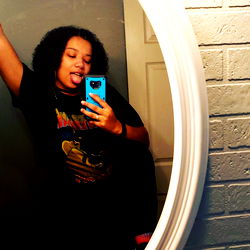 Cheeky, Stylish Instagram Model Embracing Her Individuality with a Blue Phone in Hand