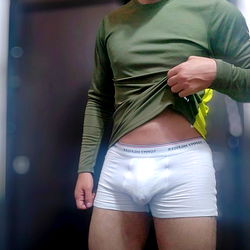 Honua showcasing his physique with a casual, candid pose