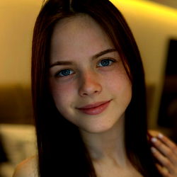 19-year-old Woman with Blue Eyes and Light Brown Hair Smiling for the Camera