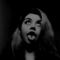 Stylized Photo of a Person with Piercings and Tongue Out,