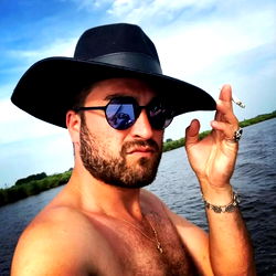 David Dillen, a Tattooed Man in a Cowboy Hat and Sunglasses Posing for a Selfie