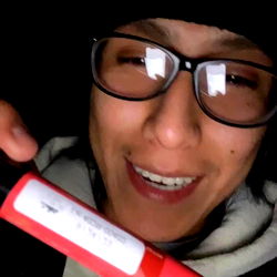 Smiling OnlyFans User with Red Vape Cartridge