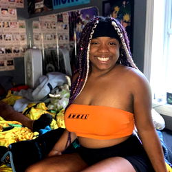 OnlyFans Model Queen_naya in Bright Orange Outfit Sitting on Bed