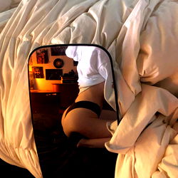 A woman posing in a mirror