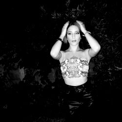 Fashionable Model Martu in Casual Outfit, Standing Against a Dark Background