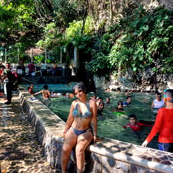 Beauty posing by a pool in swimwear