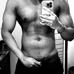 Strong and Shirtless Model Strikes a Pose in Front of Mirror