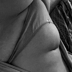 A candid OnlyFans shot of June West, a plus-size model known for her stunning figure and confidence.