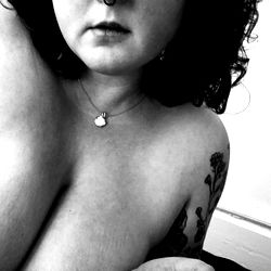 Chubbylittleghost, a captivating OnlyFans model with tattoos and a necklace.