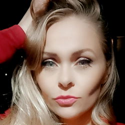 Blonde Beauty in Red Blouse Poses for Picture