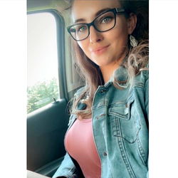 Sami Anderson, a young adult female posing in her car for an Onlyfans-style photo
