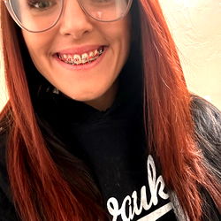 A Young Lady with Red Hair and Glasses