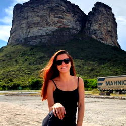 Sued Xavier Posing in Front of a Rock Cliff