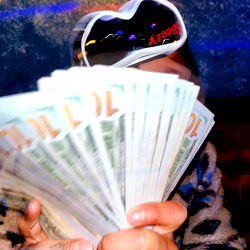 Hands Displaying $100,00 in Cash