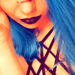 Vivid Blue Haired Goth Model with Crossed Arms