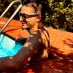 Merk enjoying a sunny day at the poolside