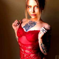 Linds, a striking OnlyFans model in a red bodysuit