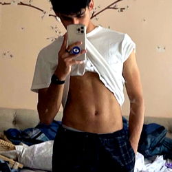 Josh the OnlyFans model with a playful, candid pose in a casual home setting.