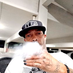 A Las Vegas ThreHundo, the rapper with a strong presence online and offline. He’s captured smoking a cigarette, showing off his tattooed hand.