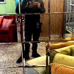 Nashawn in a Room with a Mirror and Couch