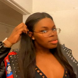 Andre, a 26-year-old model showcasing her latest outfit with a striking haircut.