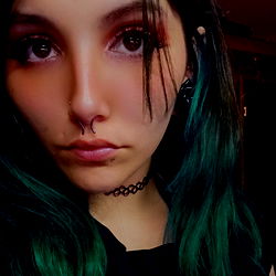 Auburn-haired model with green hair and tattoo