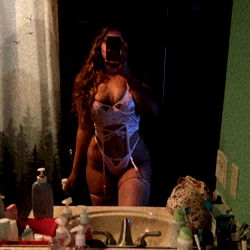 OnlyFans model Emily Hosein poses in bathroom