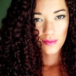 Gorgeous Amelia Simone, a San Diego-based OnlyFans model with voluminous hair and a captivating smile.