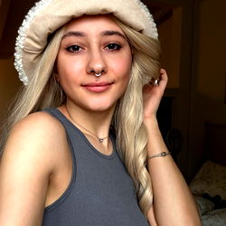 Blonde-haired model posing in a cozy room