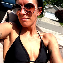 Sunglasses-Wearing Woman in Tankini and Sunglasses on Patio