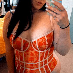 Woman in a red and white lingerie taking a selfie