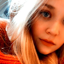 Amorie, a captivating young model with striking blue eyes and blonde hair