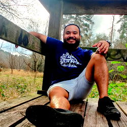 Eddie from Houston Tx poses on a wooden bench